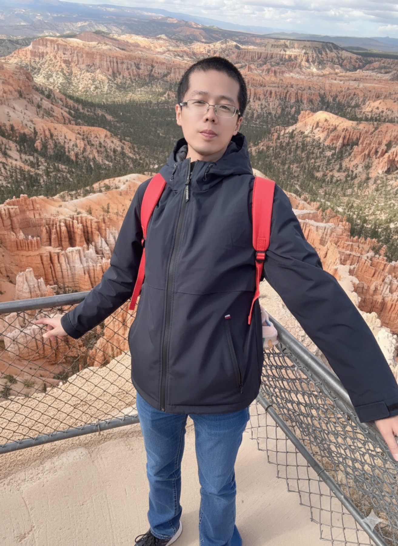 Weiyi Xia standing in front of a canyon landscape